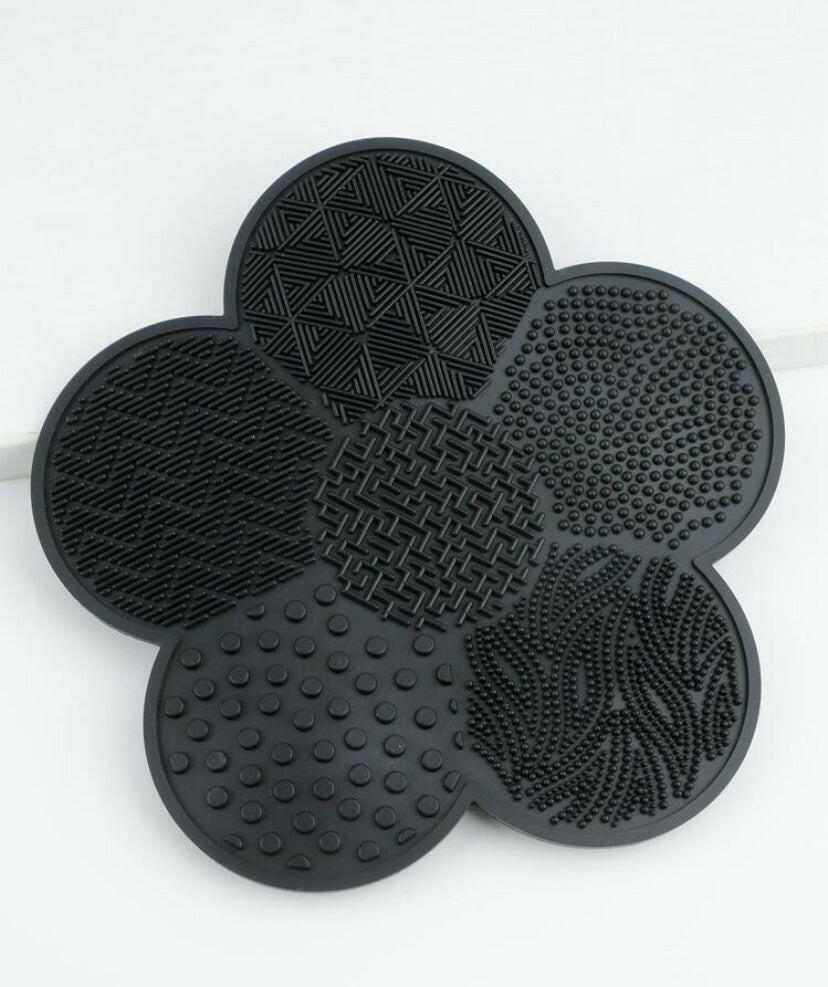 Flower shaped make up cleaning pad.