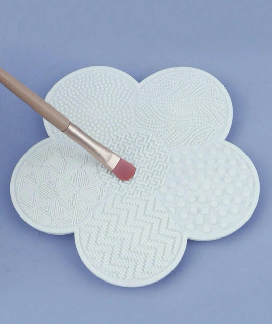 Flower shaped make up cleaning pad.