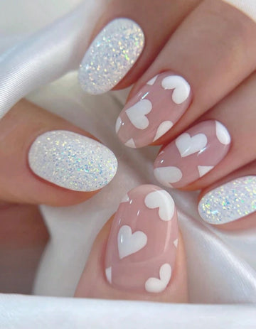 Pink oval shaped with white heart design and glitter press on nails